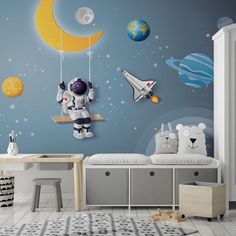 a child's room decorated in blue and white with an astronaut themed wall mural