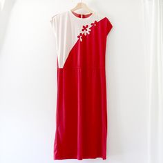 "Fun, flirty vintage dress in red with a diagonal white flower appliqué at the front. The sides have a small vent at the hem, the waist is elasticated, and there is a keyhole feature at the back neckline.  Size: Unknown Fabric: Unknown synthetic Brand: Unknown Condition: Good. Item is pre-loved, and there is some wear to the fabric (light fuzzing/thinning.) The main tag is no longer readable, but no major issues! Measurements*: Length from high point shoulder to hem: 46\" Bust: 19\" Waist: 18\" relaxed, 21\" stretched Hip: 21\" *All measurements are taken flat- please double where appropriate and compare with a garment you own to determine fit. Unless otherwise noted each item has been cleaned in accordance with instructions on tag and has been stored in a smoke free/pet free environment. Retro Skater, Red And White Dress, Original Beanie Babies, Stretchy Skirt, Vintage Hawaiian Shirts, Union Made, Black Leather Backpack, Fabric Light, Vintage Hawaiian