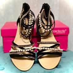 Beautiful Flat Sandals With Black, Gold, And Pearl Straps. These Gorgeous Sandals Go Beautifully What’s Your Favorite Summer Outfit And Add A Little Bit Of Jewlery To Your Feet. There Us A Zipper On The Back Of The Heal/Sandal To Allow You To Easily Slip In, Zip Up, And Go. No Tying Needed. New In The Box! Bought At Shoedazzle, But Ended Up Wearing Only The Other Color Version. Selling These Brand New/Never Worn. Size 6.5. Black Sandals With Chain Strap For Party, Black Heels With Chain Strap, Black Synthetic Sandals With Chain Strap, Summer Black Heels With Chain Strap, Black Heels With Chain Strap For Summer, Heal Sandal, Flat Black Sandals, Pearl Straps, Shoe Dazzle