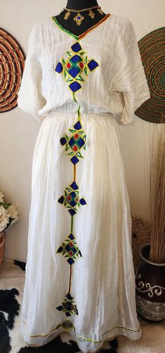 Ethiopian eritrean traditional. Handmade with organic cotton, this dress is not only fashionably chic but also environmentally friendly. Channel the elegance of Ethiopian culture with our stunning habesha dress Handwoven cotton fabric Embroidery design Includes netela Hand wash/dry cleaning Fabric Embroidery Design, Ethiopian Culture, Habesha Dress, Fabric Embroidery, Traditional Dress, Dress Clothes For Women, Traditional Dresses, Embroidery Design, Environmentally Friendly