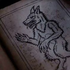 an old book with a drawing of a wolf on it