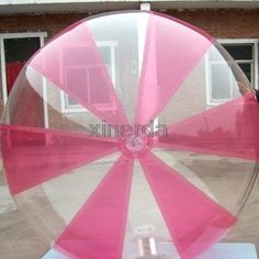 an inflatable ball sitting on top of a white table next to a building