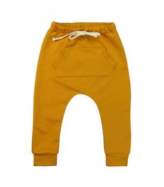 a small child's yellow sweat pants with white drawstrings on the bottom