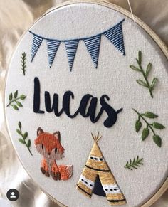 a close up of a embroidery on a piece of cloth with the word lucas written in it