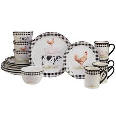 a black and white set of dishes with farm animals painted on the plates, cups and saucers