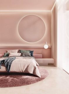 a bedroom with a circular bed in the middle and pink walls on the other side