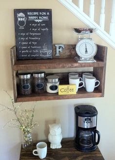 a shelf with coffee cups and an alarm clock