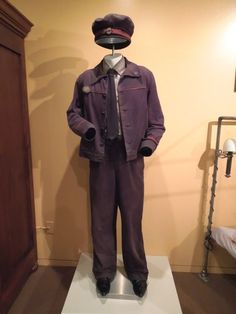 a mannequin wearing a suit and tie in a room