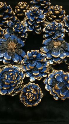 blue and gold flowers are arranged in the shape of a circle on a black background