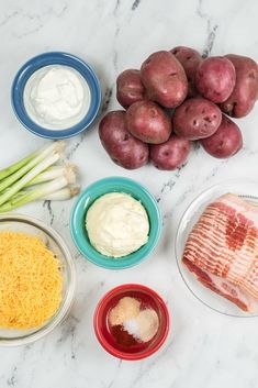 potatoes, celery, cheese and other ingredients are laid out on a marble surface