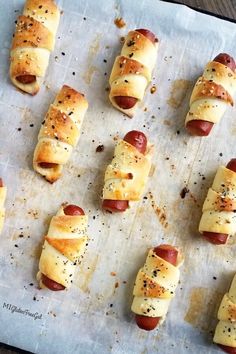 hotdogs wrapped in bread on a baking sheet ready to be baked and eaten