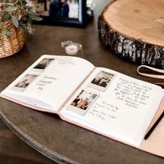 an open book sitting on top of a table next to a wooden slice of tree