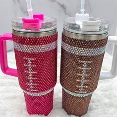 two coffee mugs decorated with swaro - bead designs and toothbrushes