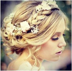 a woman with blonde hair and flowers in her hair