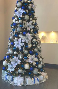 a decorated christmas tree with blue and silver ornaments