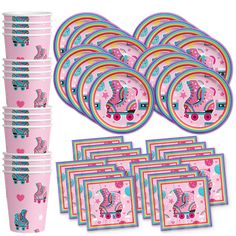 a pink party pack with unicorns and hearts on the plates, cups and napkins