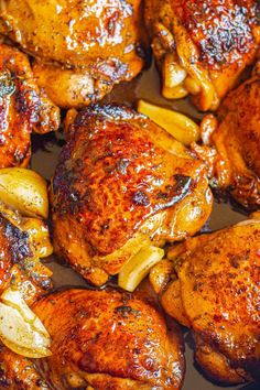 chicken and onions cooking in a pan on the stove