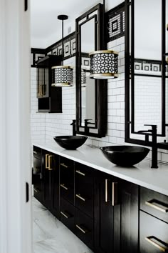 a bathroom with two sinks and mirrors on the wall next to each other in black and white