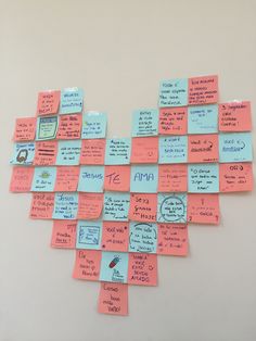 many sticky notes are arranged in the shape of a heart