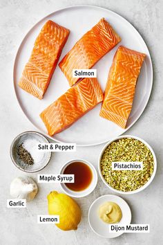 salmon and other ingredients on a plate with the words salmon, salt, pepper, maple syrup, garlic, lemon, seasoning