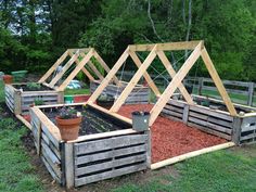 an outdoor garden area with raised wooden planters