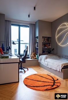 a bedroom with a basketball rug on the floor in front of a bed and desk