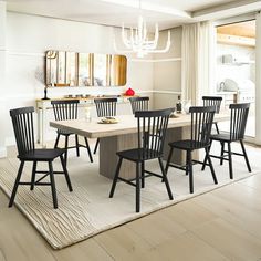 a dining room table with six chairs and a chandelier hanging from the ceiling