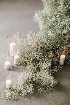 candles and baby's breath flowers on the ground