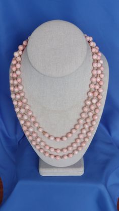 Vintage Angel Skin Coral Necklace.  This elegant and beautiful single strand hand-knotted necklace is 62 inches in length, providing lots of options for wear.  The hand polished natural pink coral beads are 1/4 inch in diameter.  The necklace weighs 3.3 oz. Elegant Pink Beaded Necklaces With 8mm Beads, Elegant Pink Beaded Necklace With 8mm Beads, Elegant Pink Necklaces With 8mm Beads, Angel Skin, Hand Knotted Necklace, Knotted Necklace, Vintage Angel, Coral Necklace, Pink Coral