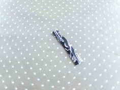 a toothbrush laying on top of a polka dot sheet