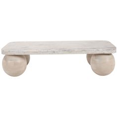 a white marble bench with two balls on it