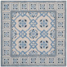 a blue and white rug with an intricate design