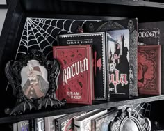 there are many books on the shelf in this book case, and one is black with red lettering