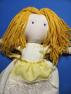 a doll with yellow hair and white dress