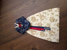 a piece of cloth with an ornament on it sitting on top of a wooden floor