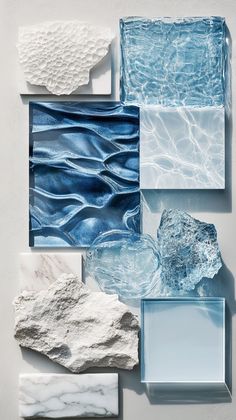 several pieces of art made out of glass and stone, all in shades of blue