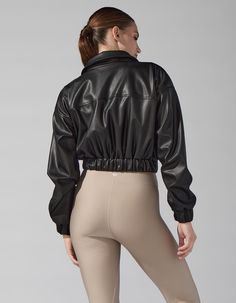 Drop a style bomb this season in our much awaited Harlow Leather Jacket! Made from the softest, finest faux leather, you can dress this leather jacket up or down. Pair with our Marvel Legging set, or layer with pieces you already own for a chic and sporty look.  Fit: slightly cropped, true to size  Side pockets  Luxurious, sift faux leather    60% Polyurethane 40% Polyester  Model is wearing a size small  Made in USA Washing Instructions:Dry Clean only Sporty Look, Black Friday Sale, Summer Sale, Best Sellers, Black Leather, Coats Jackets, Faux Leather, Leather Jacket, Marvel