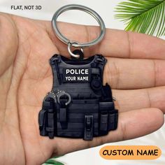 a police officer keychain is shown in the palm