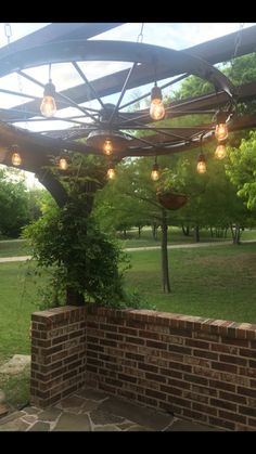 an outdoor patio with lights hanging from the ceiling