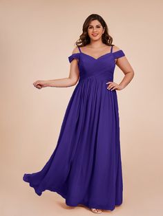 a woman in a purple dress posing for the camera with her hands on her hips