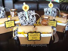 four gift bags with happy eid tags on them sitting on a table in front of a couch