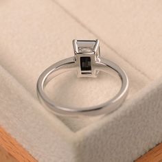 This ring features a 6*8 mm emerald cut natural black spinel and sterling silver finished with rhodium. Customization is available. It is made by hand, and it will take about 7 days to finish the ring after your payment is completed. Main stone: natural black spinel Main stone weight: Approx 1.85 ct Metal type: sterling silver finished with rhodium Customization is available, I also can make it with 14k solid gold (white or yellow or rose) and diamond accent stone, just feel free to contact me. Emerald Cut Solitaire Ring, Black Gemstone Ring, Emerald Cut Solitaire, Black Spinel Ring, Ring Emerald Cut, Spinel Ring, Ring Emerald, Ring Black, Black Spinel