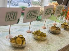 bowls filled with bananas sitting on top of a table next to signs that read dill sour