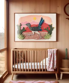 a baby's room with a painting on the wall and a crib in front of it