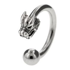 a silver ring with an animal head on the front, and a ball in the middle