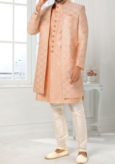 Readymade Art Silk Sherwani, and Jacket. Art Dupion Aligarhi Ready Made Trouser. Resham, Sequences, and Zari Work. Crafted in Chinese Collar Neck, and Full Sleeve. Faux Satin Lining with Plain Work. High-Quality Matching Buttons. Please Note: The footwear shown in the picture is for presentation and photography purpose only. Color: There might be slight color variation due to lightings and flashes while photo shooting. The color may also vary because of different screen resolutions. Wash Care: D Fitted Long Outerwear For Festive Season, Festive Long Fitted Outerwear, Elegant Festive Straight Kurta Outerwear, Festive Long Outerwear With Resham Embroidery, Formal Raw Silk Nehru Jacket With Traditional Drape, Eid Nehru Jacket With Cutdana On Raw Silk, Formal Nehru Jacket In Raw Silk, Traditional Long Coat For Festive Season, Festive Bandhgala With Cutdana And Long Sleeves