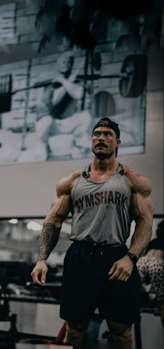 a man standing in front of a gym machine