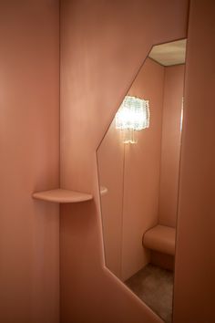 a bathroom with a mirror and shelf in it