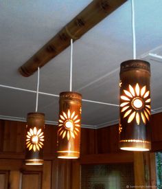 three lights hanging from the ceiling in a kitchen with wood paneling and wooden cabinets