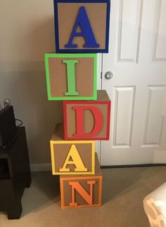 colorful blocks spelling out the word aid in front of a door